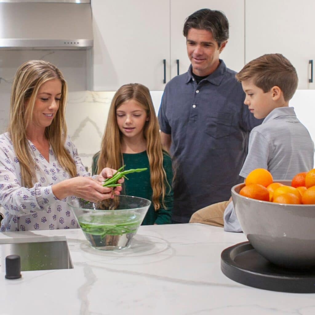 family cooking in riverside kitchen with clean water