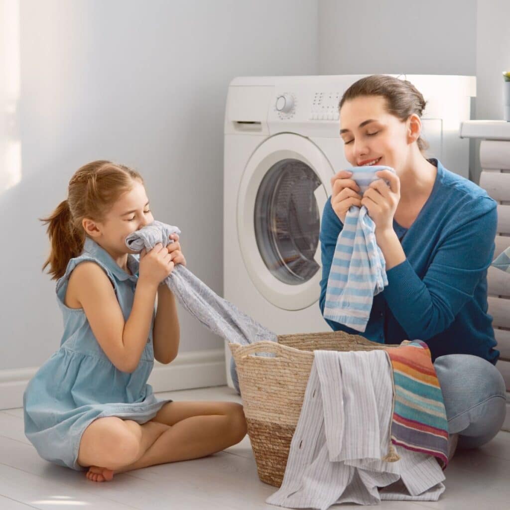 mother and daughter doing laundry in riverside with soft water